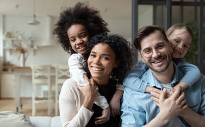 Portrait of a happy couple with their kids at home