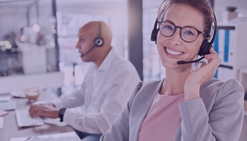 Portrait of a smiling female customer support representative taking calls